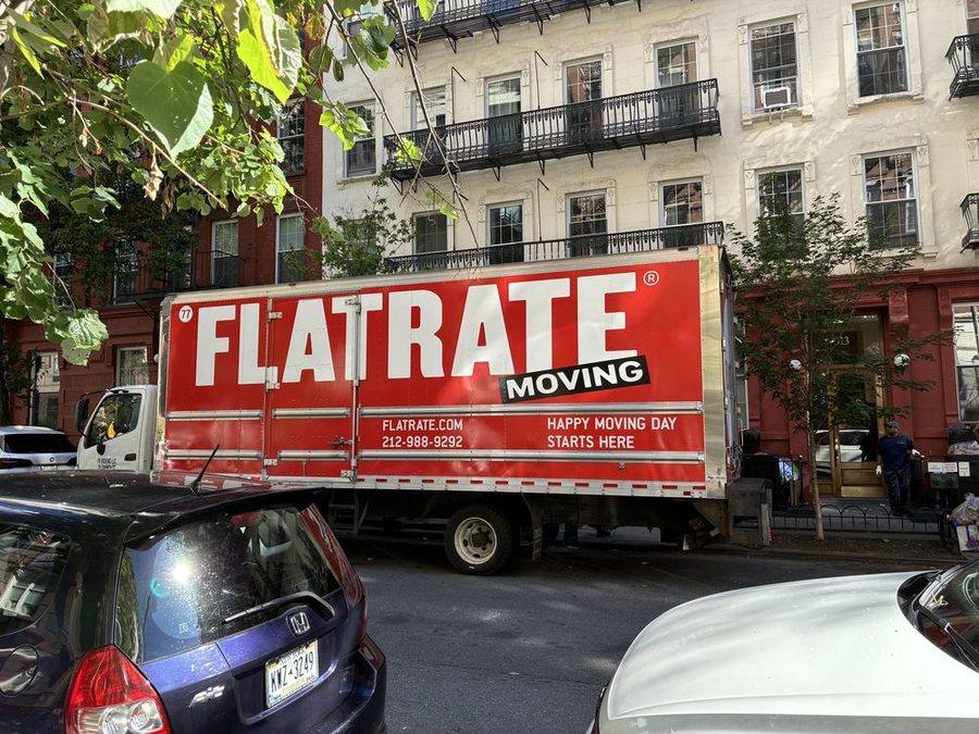 FlatRate Moving truck on a tree-lined street