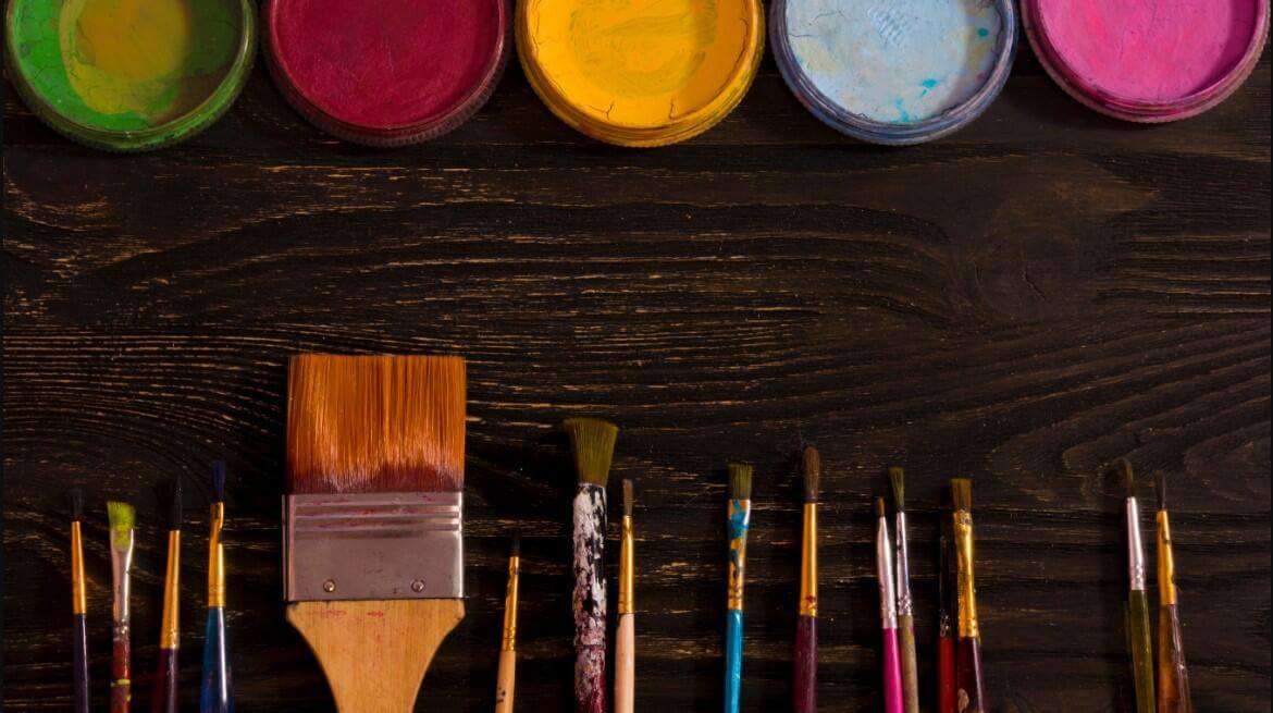 Brushes and color paints on a table