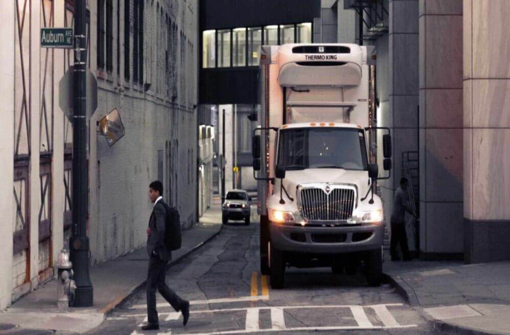 White truck on a narrow street