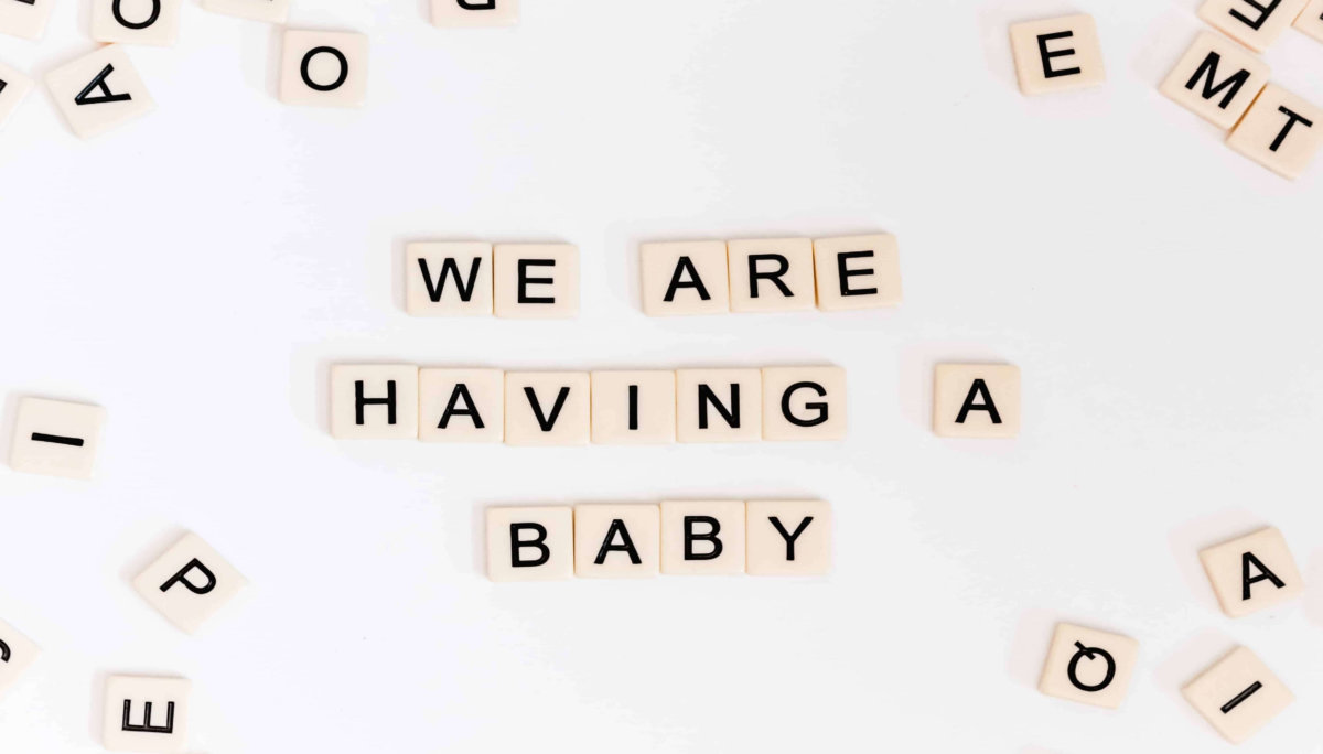 We are having a baby phrase with scrabble tiles
