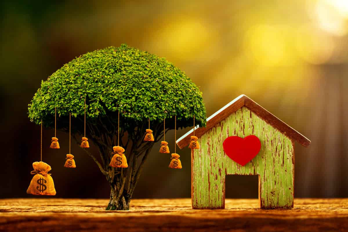 House model and red heart for family and big money bag of tree as destinations is saving put on the wood in the morning sunlight
