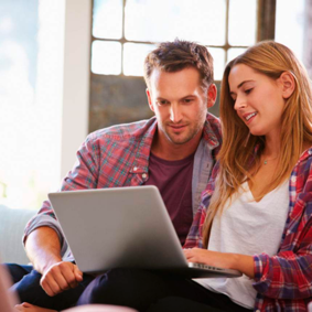 Two customers looking at their laptop