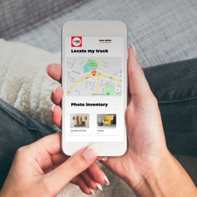 A person holding a smartphone, using the FlatRate App