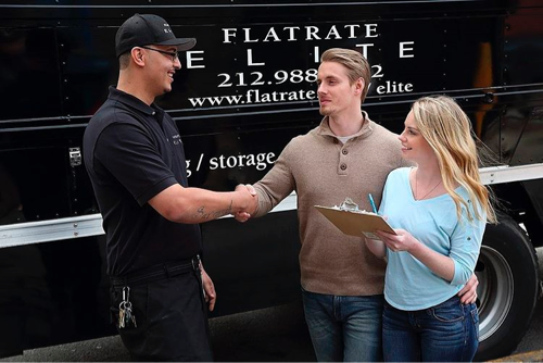 A mover shakes hands with some customers