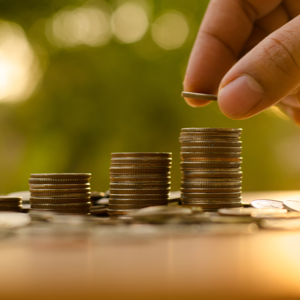 A person stacks some coins