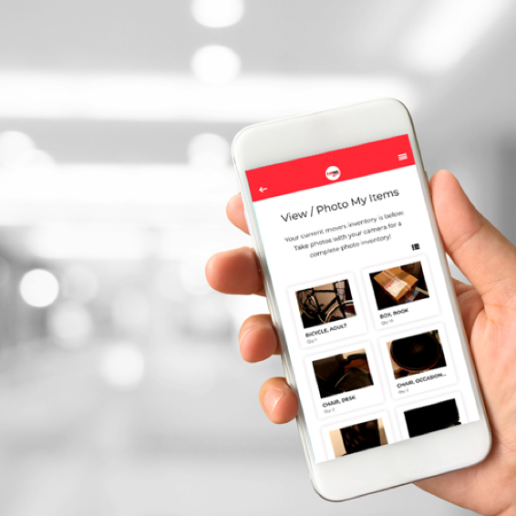 A person holds a phone on the photo screen of the FlatRate app