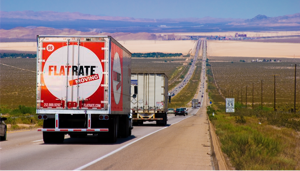 FlatRate truck drives down a highway