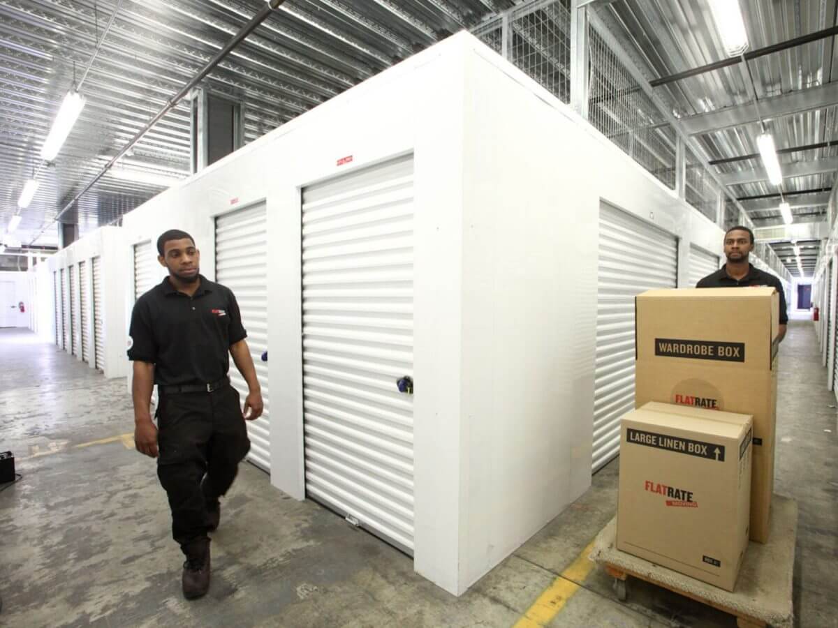 Movers loading items into storage