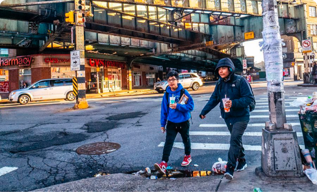 Two people cross the street in Bushwick