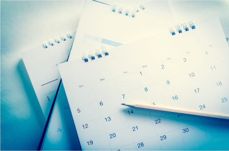 A stack of calendars on a desk