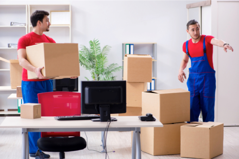 A pair of movers arrange a room