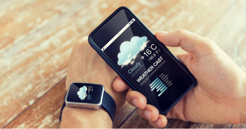 A person checks the weather on their devices