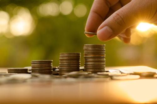 A person stacks coins