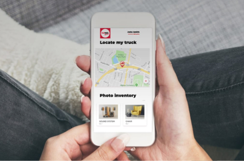 A person holds a phone with the MyFlatRate app open
