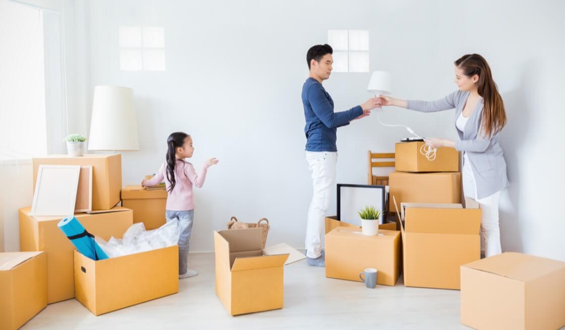 Couple and doughter unpacking