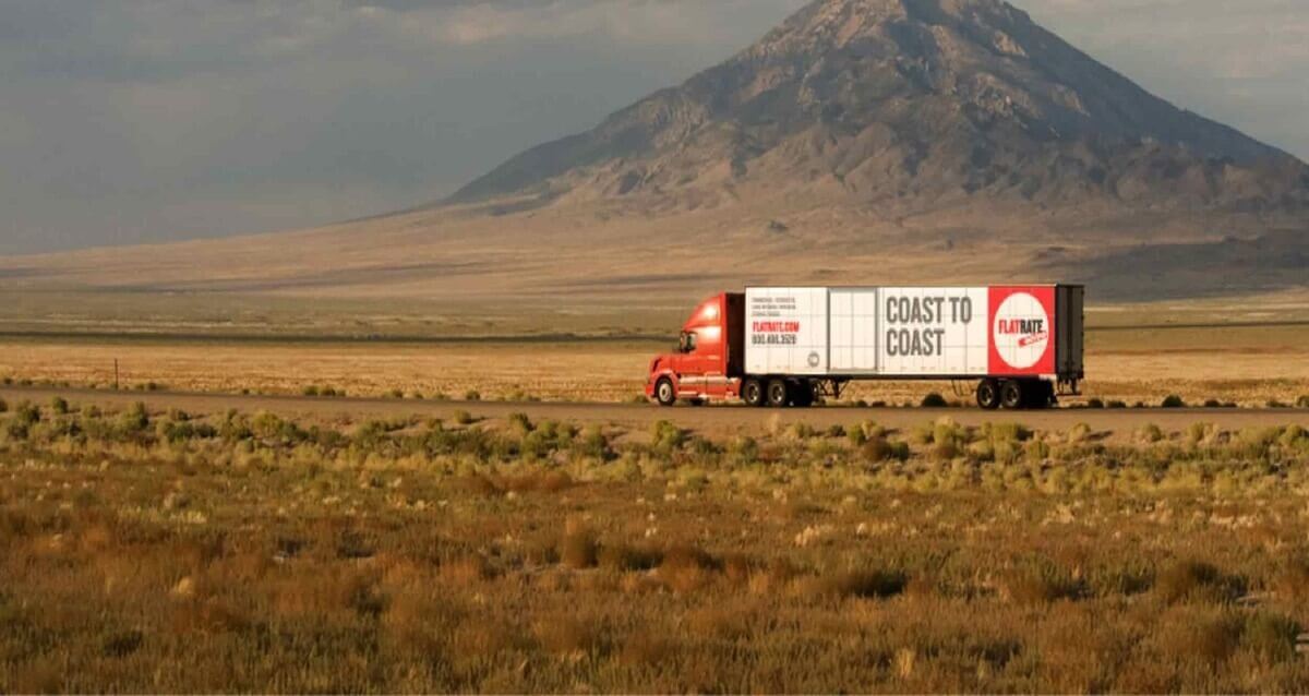 Flatrate truck on the road with a mountain behind
