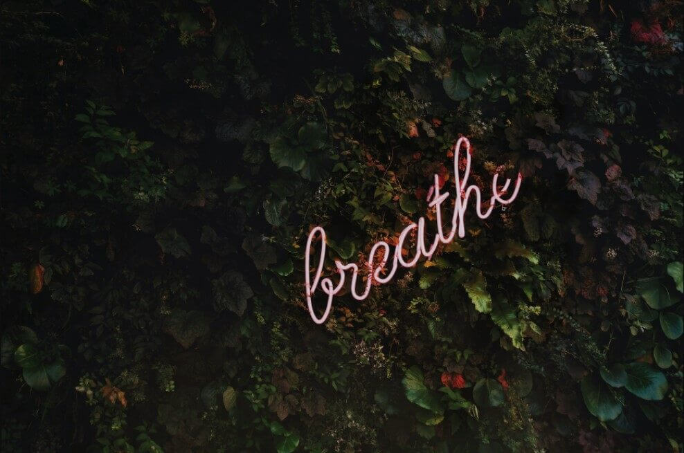 Pink neon light with the Breathe word