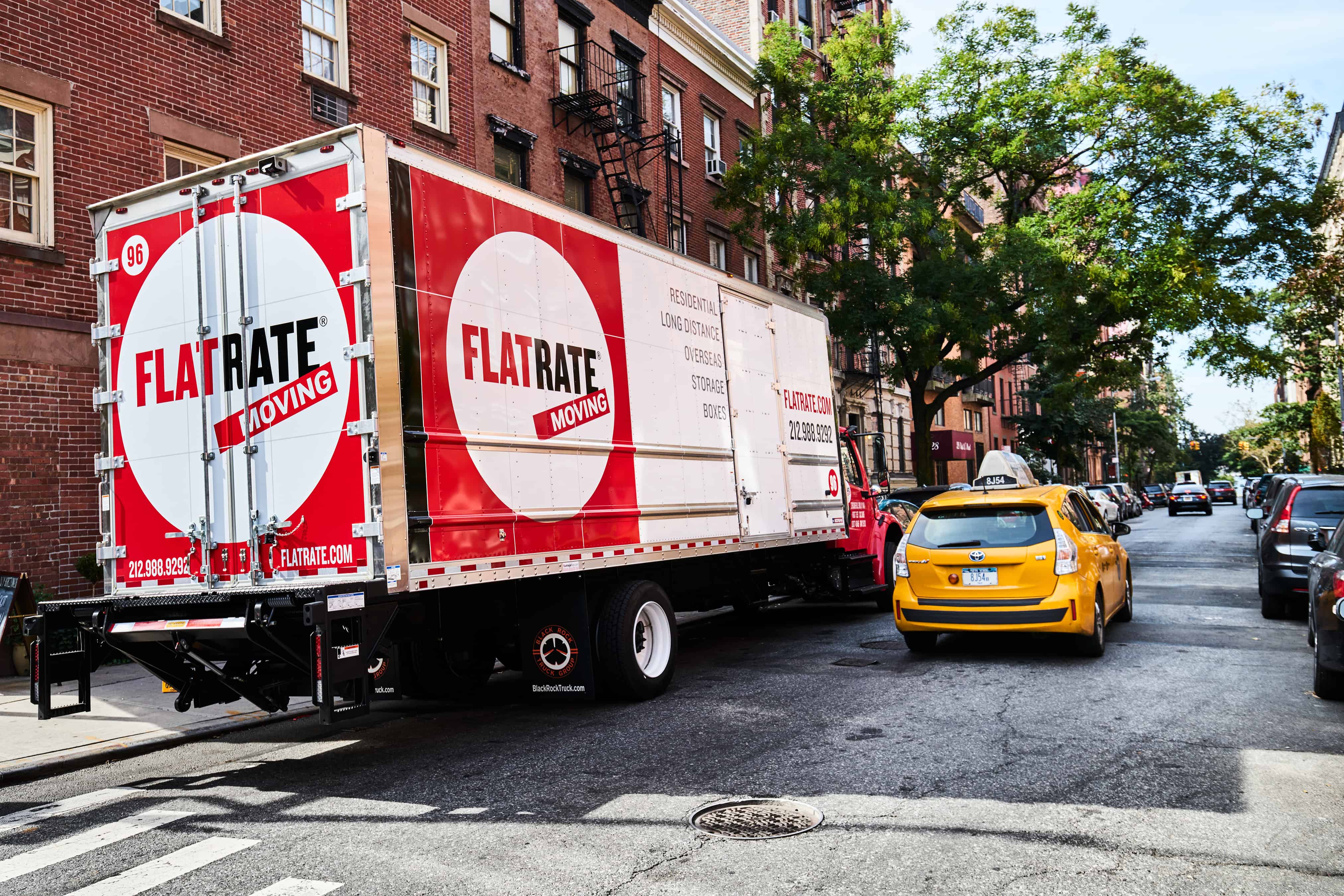 FlatRate Moving Truck parked on the side of a neighborhood street