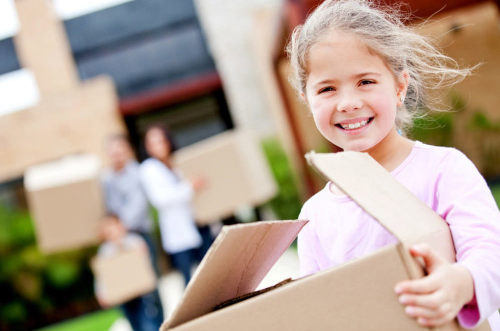 girl carrying a box on moving day