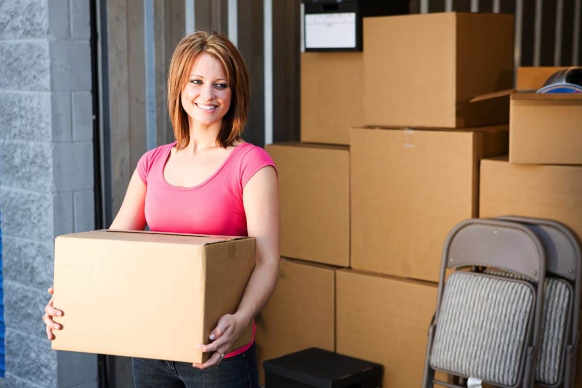 Woman standing next to a storage unit