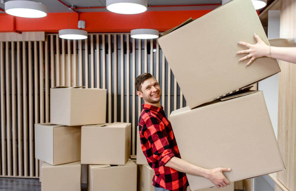 Man with a red shirt moving boxes