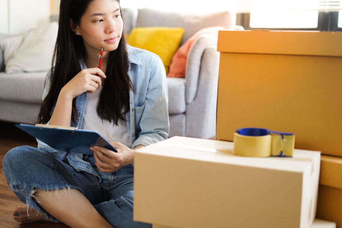 Woman with moving boxes and clip