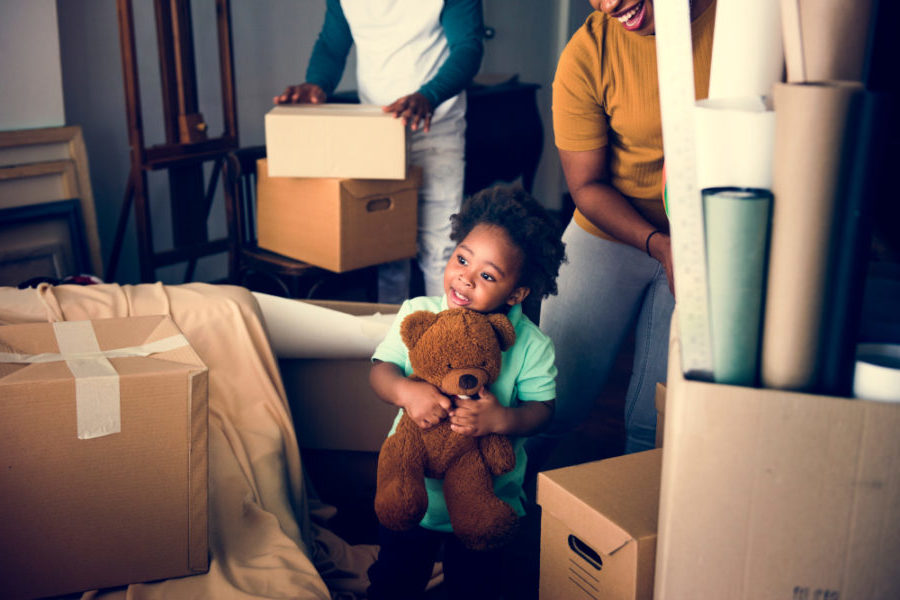 moving boxes kid with teddy bear