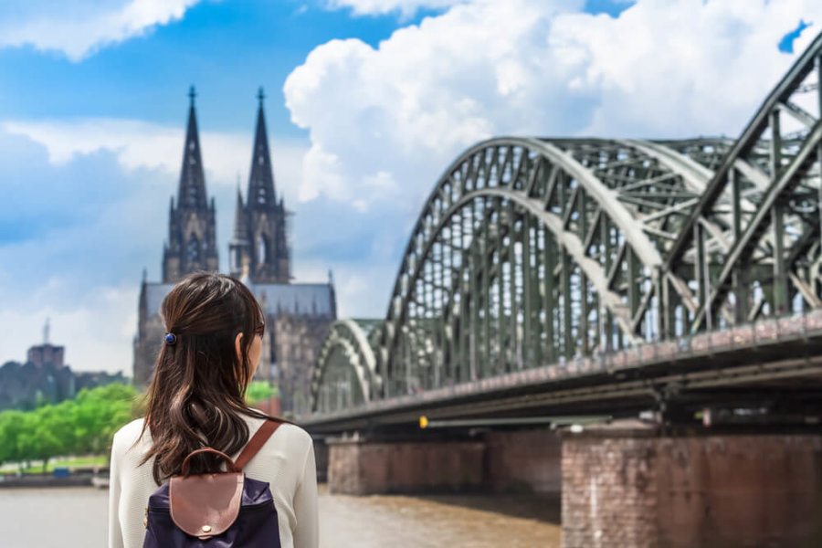 woman looking at bridge and castle in germany