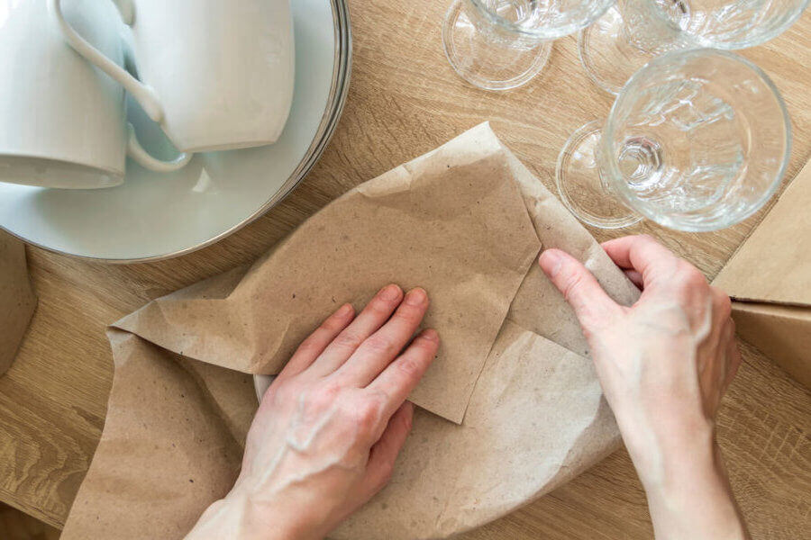 Person hands packing dishes