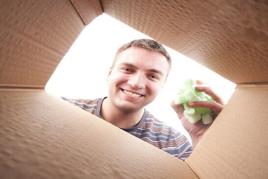 Guy packing on a box