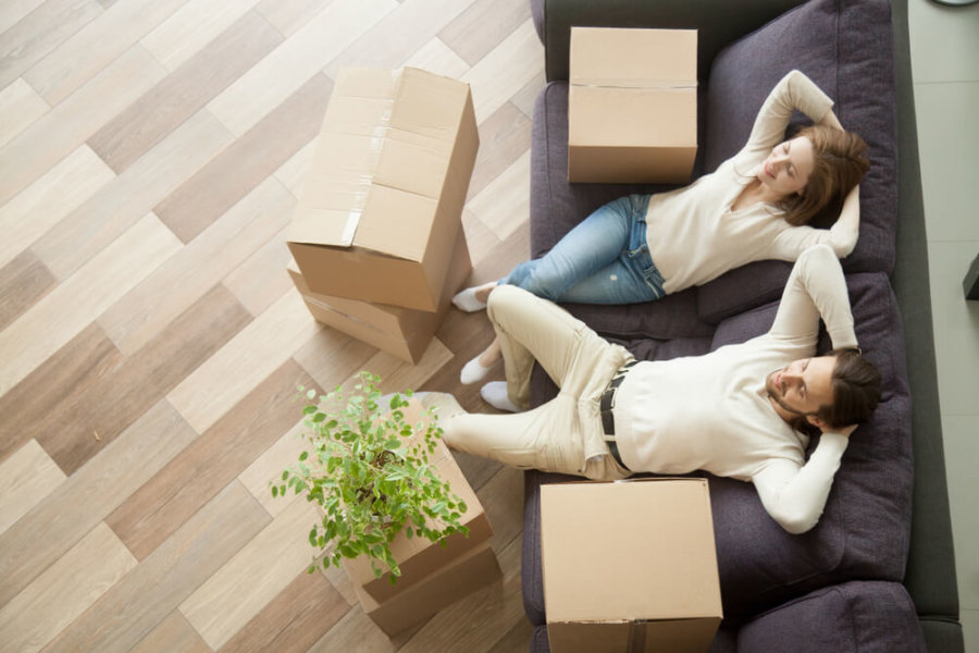 couple relaxing on the couch after packing boxes