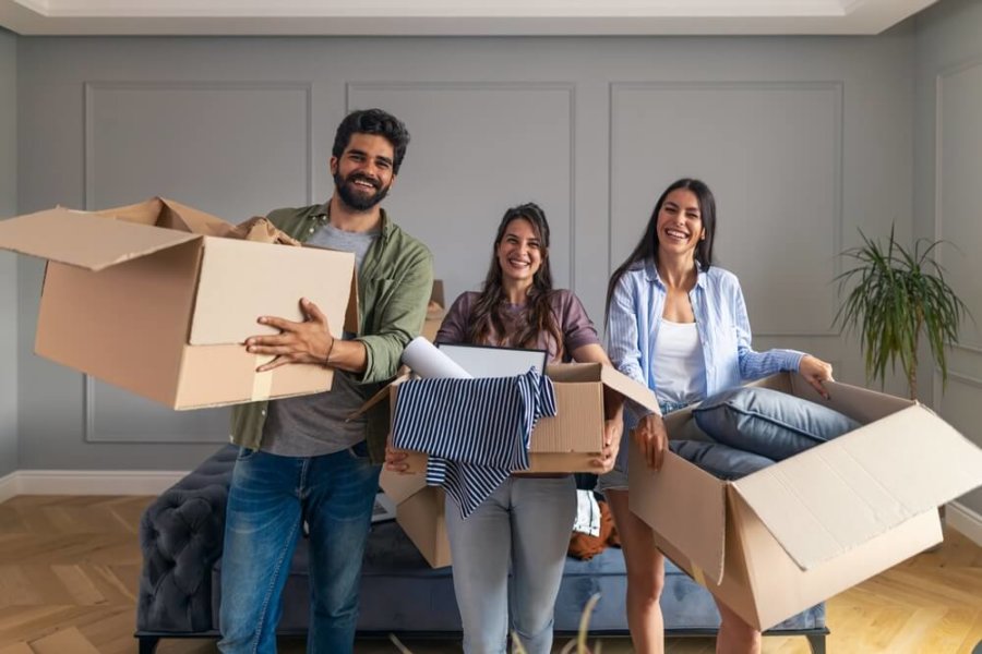 roommates with moving boxes