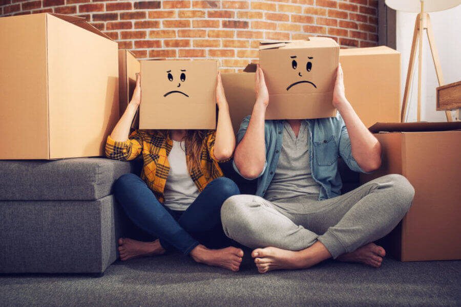 A man and a woman with boxes on their heads