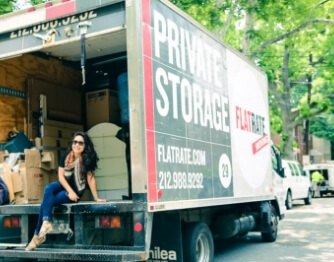 Lady sitted on the back of a truck