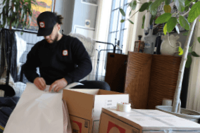 FlatRate Mover Packing Items Into Box Common Mishaps When Moving Long Distance