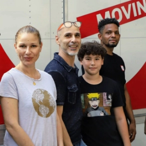 Family stand near the FlatRate truck