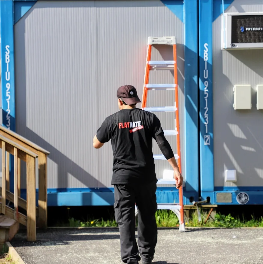 Flatrate Mover standing in front of a trailer