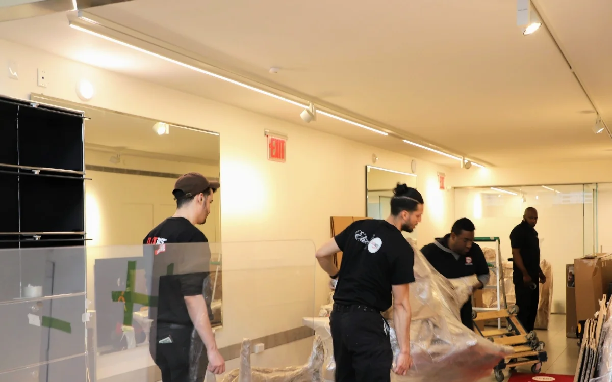 Team member moving boxes inside a hall