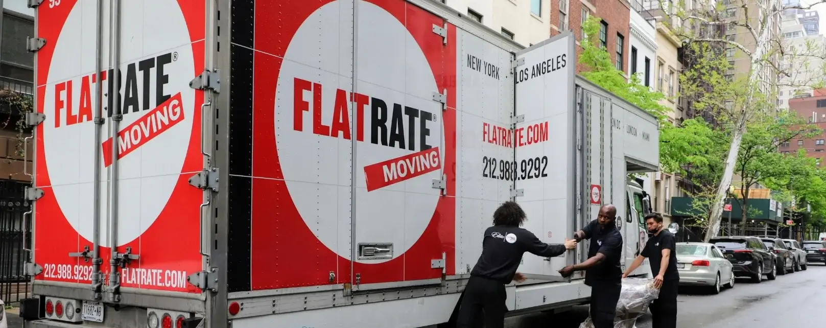 3 movers working near the Flatrate truck