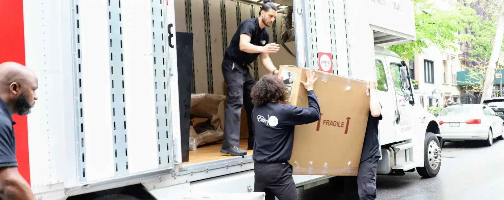Movers moving a fragile box