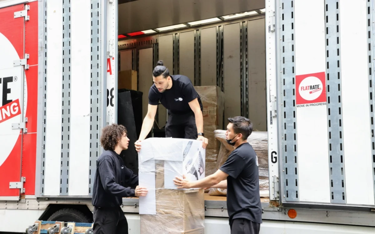 Three Flatrate mover loading a truck