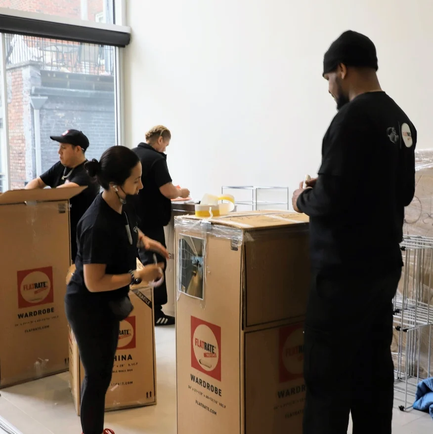The Flatrate team working on packing an office