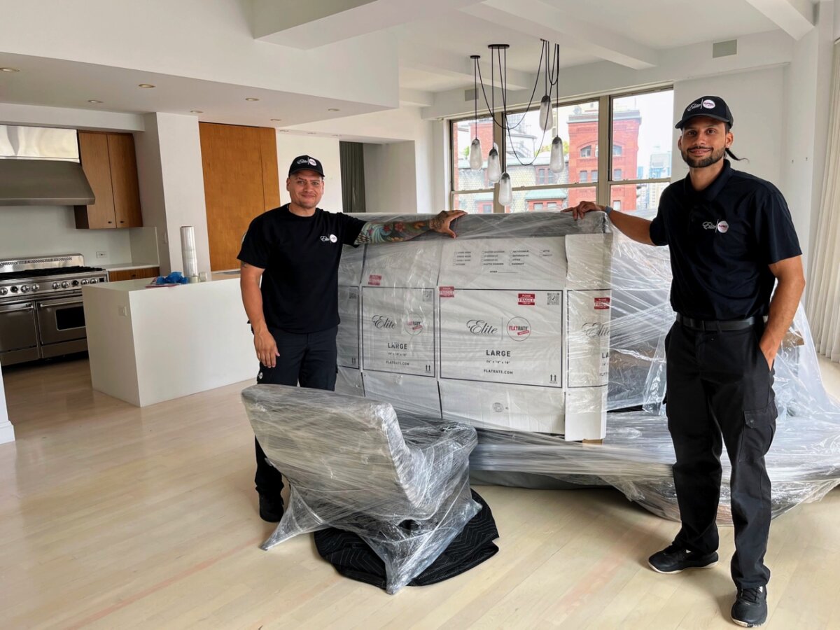 FlatRate Elite Movers next to packed furniture