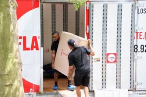 FlatRate Movers loading a large box into moving truck 300x200 Automation Techniques   How Are They Effective in Moving Homes?