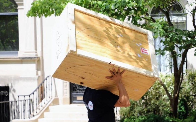 Man moving a custom box cratted for moving
