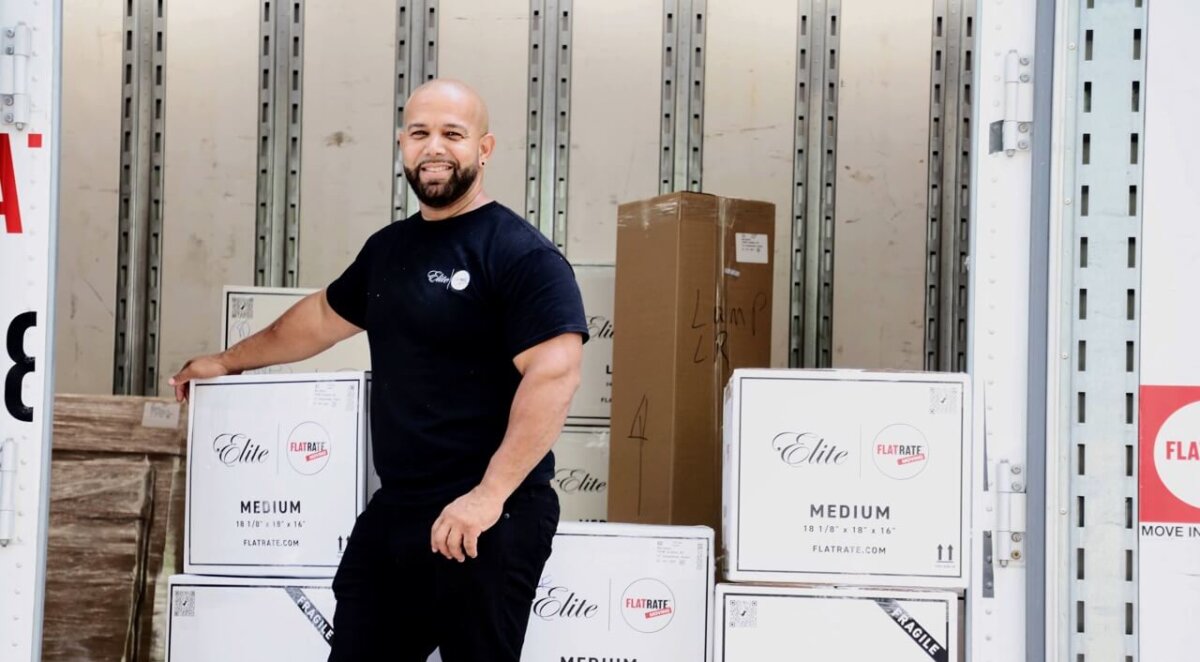 Flatrate Moving mover standing inside moving truck