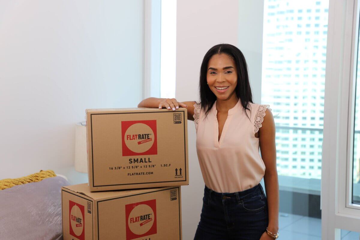 FlatRate Moving client with FlatRate Moving boxes during a move.