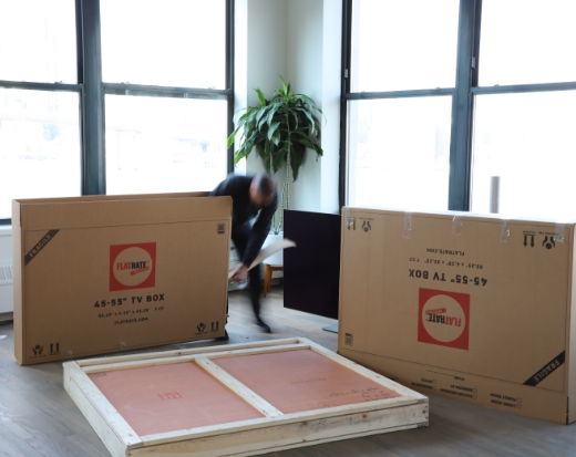 Man packing art with flat boxes