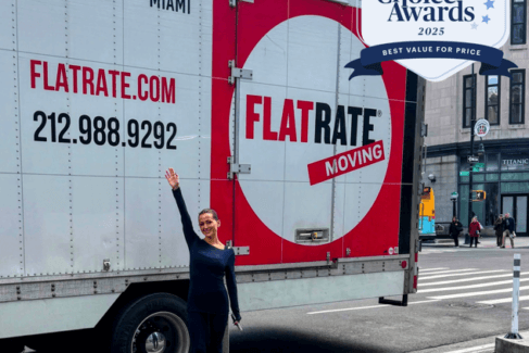 FlatRate Moving truck with a client and a winner badge