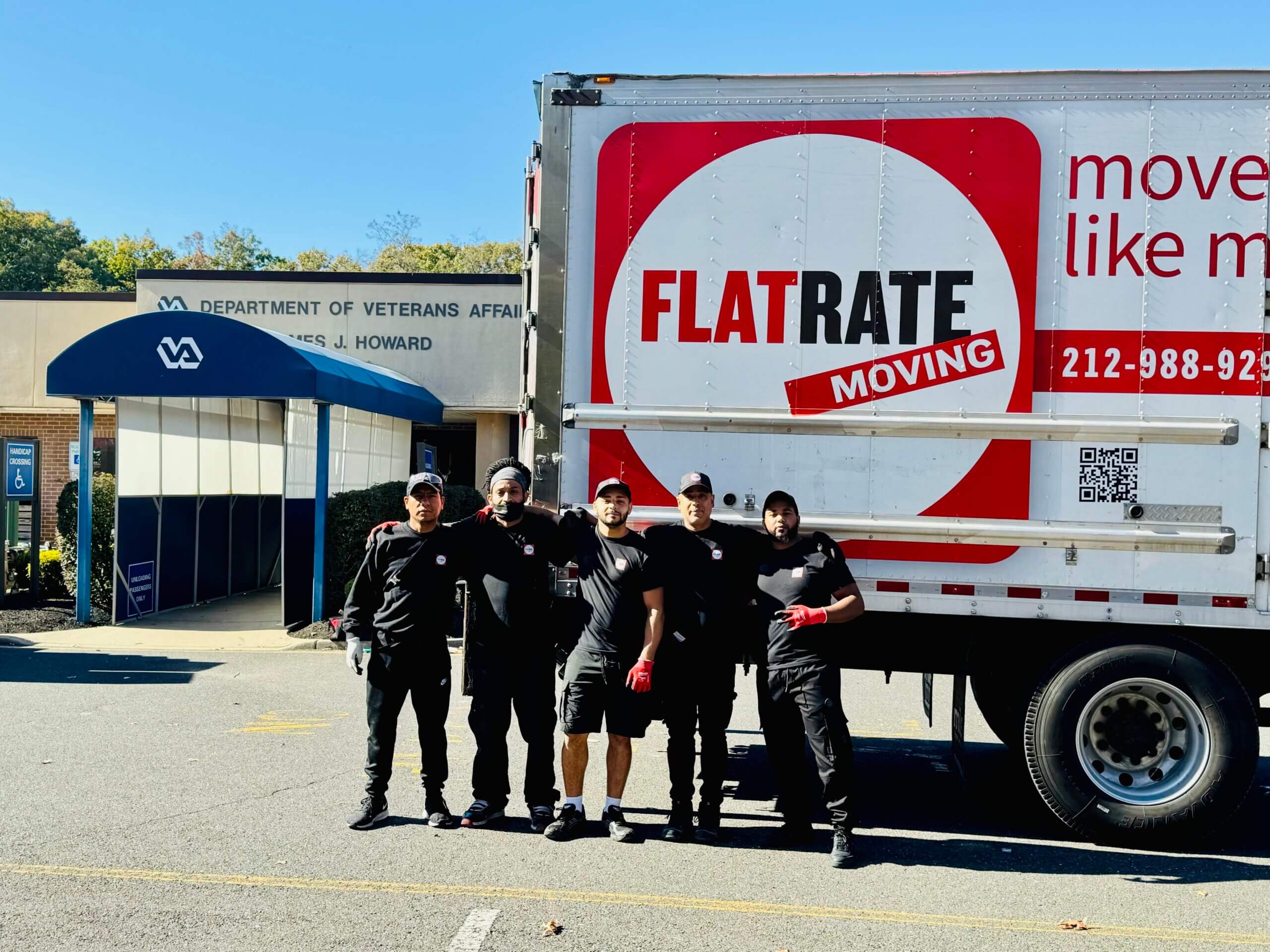 Flatrate movers posing near the truck